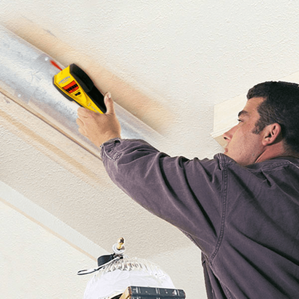 stud finder being used on the ceiling