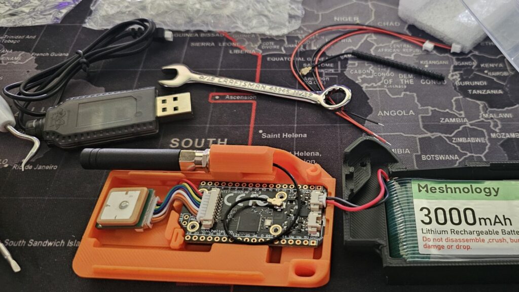 LoRa Comms with the Heltec V4 Dev Board The MESHNOLOGY ESP32 LoRa V4 Development Board + L76 GNSS Module + 3000mAh Battery in its final stages of assembly into a 3D printed case.